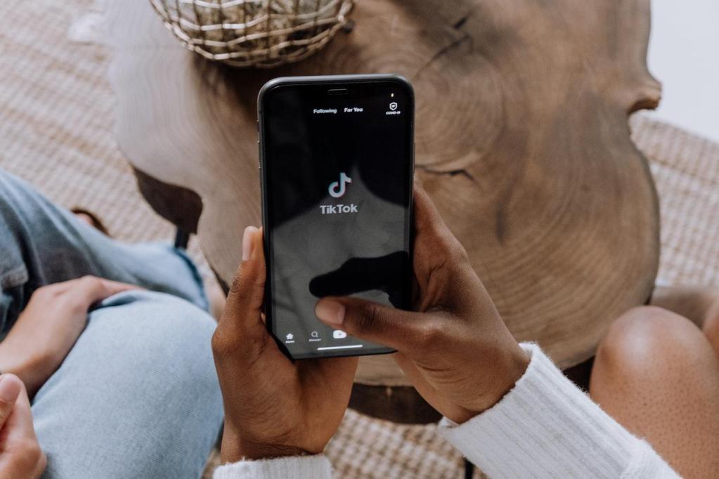 man holding phone going to tiktok